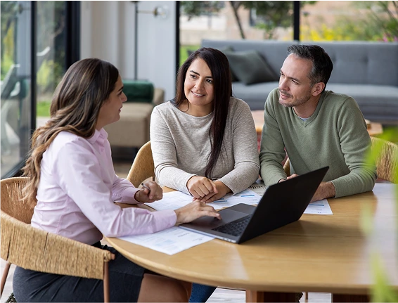 A couple consulting with a lady and a laptop